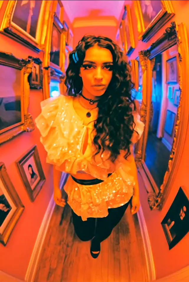 Laura Pieri in a vivid red and blue hallway portrait